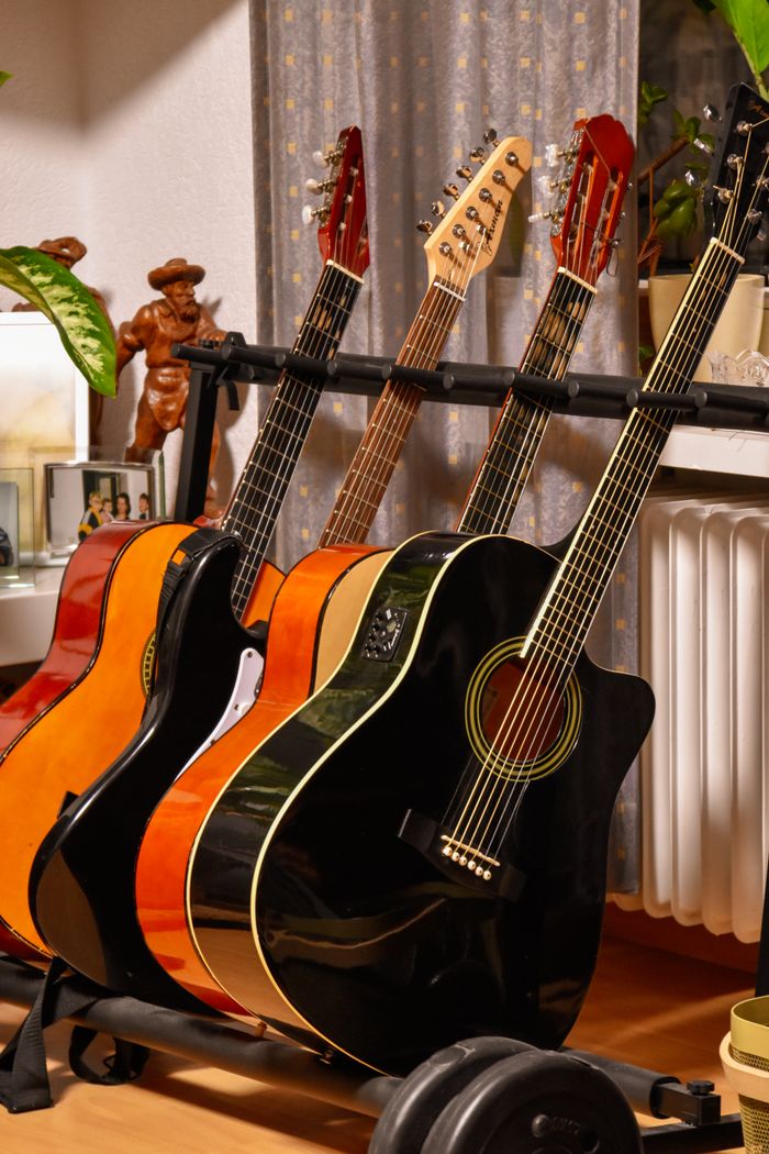 Crafting Captivating Headlines: Your awesome post title goes here A variety of acoustic guitars on a stand, showcasing their vibrant colors and detailed craftsmanship.
